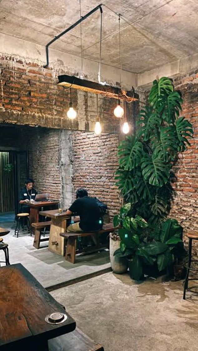 encycoffeedia interior with exposed brick and plants